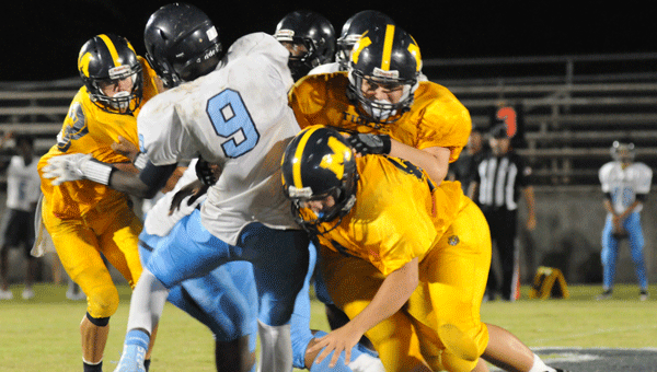 A horde of McKenzie defenders swarm a Barbour County player during the Tigers’ win over the Jaguars Friday.  The McKenzie defense has limited opponents to just 16 in the past two weeks.