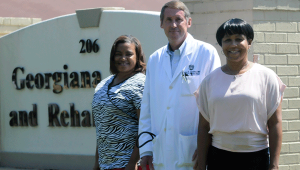  Dr. Charles Tompkins (center) was named Georgiana Health and Rehab’s new medical director.  Also pictured is Tinecha Posey (left) and Matilda Hartley (right).