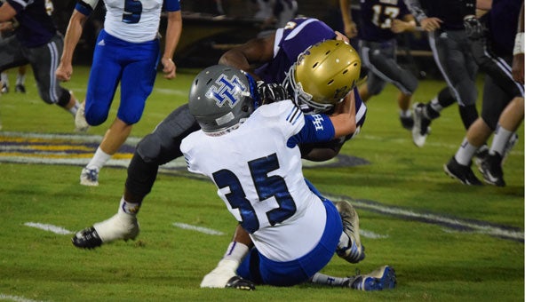 HHS sophomore wide receiver/linebacker Treton McGough tackles a Geneva player. 