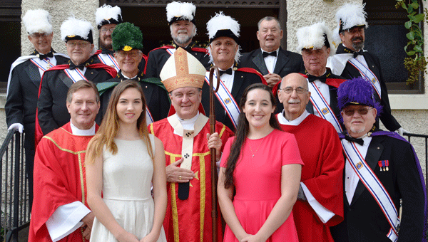 Anne-Grace Hartman and Anna Wright, both high school seniors, received the Sacrament of Confirmation Sunday, Oct. 2.  Also pictured is Fr.  Wayne Youngman,  Archbishop Thomas Rodi, Deacon Robert Bailey and the Knights of Columbus Fourth-Degree Honor Guard.