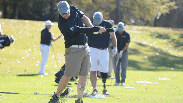 Adam Jennings warms up prior to the Cambrian Ridge-hosted golf tournament for wounded veterans Wednesday.