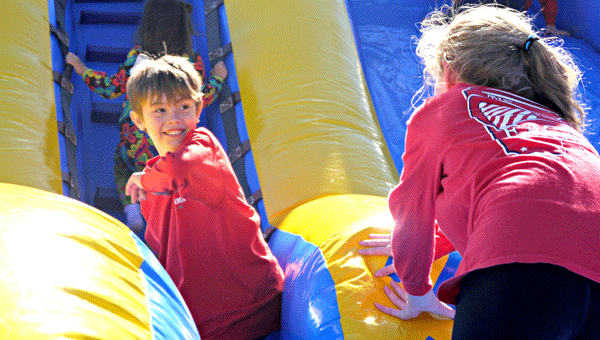 Youngsters enjoyed romping on the inflatables, particularly the giant slide at the holiday market in McKenzie.