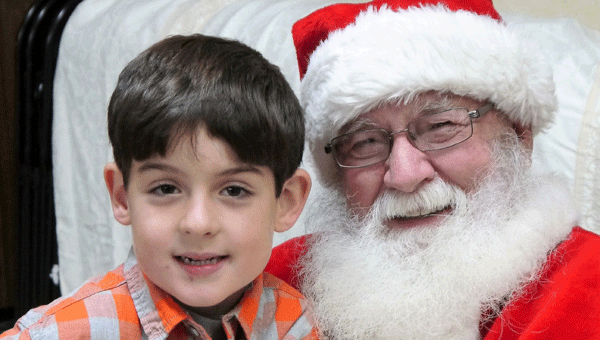 Preston Lowery visits with Santa at the Three Arts Club of Georgiana and Chapman's Christmas Bazaar on Saturday. 