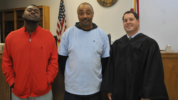 Judge Adrian Johnson (right) honored Tyler Cook (left) and Worlie Pryor (middle) with certificates of completion upon finishing a 12-month drug court program.