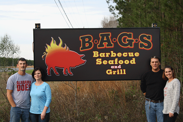 Sandy and Brandy Smith (left) and Giles and Angie Bryan (right) opened their first restaurant, B.A.G.S. Barbeque, Seafood and Grill in December. B.A.G.S. is located on Highway 331 just before Brantley City Limits.