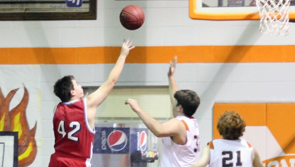 Dawson Wilcox goes up over two of Monroe’s defenders to lay up two points, in Eagle’s win 40 to 24.