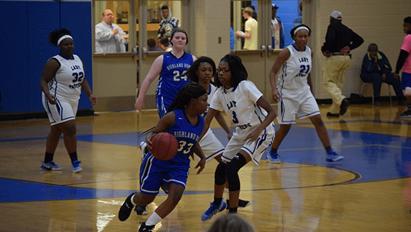 Pictured is HHS Lady Squadron player Allera June charging past the Georgiana Lady Panthers. 
