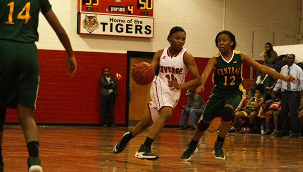 Pictured is LHS Lady Tiger freshman Vaniyah Williams dodges the Central Lady Lions. 