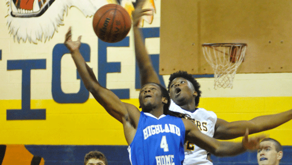 McKenzie’s Jacquez Smith swats a Highland Home layup attempt in the opening minutes of the first quarter.
