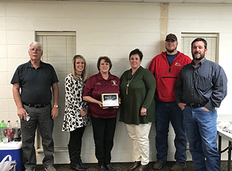 Pictured is Jane Lester (center) with her family.  Last Friday,  a retirement party was held for Lester at the Crenshaw County Emergency Management Agency office. 