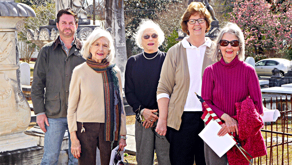 From left, Pioneer Cemetery Preservation Association members Galahad Smith, Myralyn Watson, Anne Feathers, Claudia Lewis and Annabel Markle (not pictured: Charles Newton) pose in front of some of the historic cemetery’s older monuments during a recent visit to the cemetery. The group is looking ahead to more fund raising and grant writing to allow them to continue their repair and restoration work. 