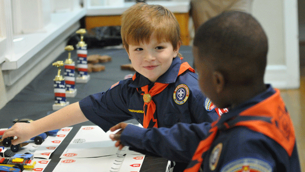 Cameron Croley (left) and Caleb Rhodes (right) prepare to face off during Saturday’s Cub Scouts pinewood derby.