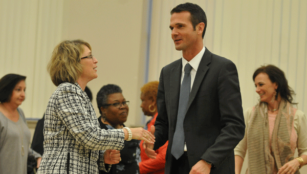 Jennifer Burt, director of Career and Technical Education in the Butler County School System, congratulates John Strycker upon his naming as the system's next superintendent.